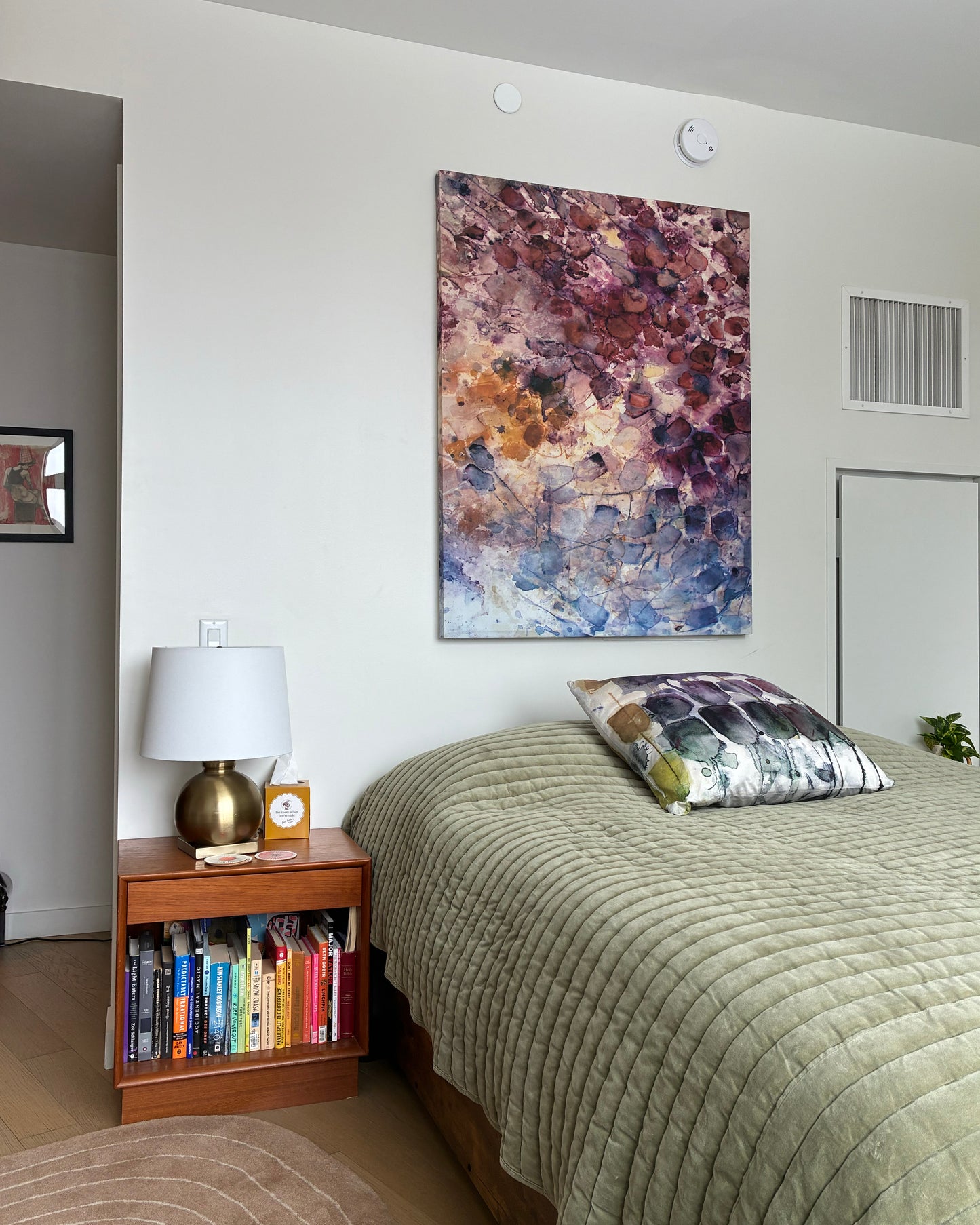 Rare Earth tea-printed wall art on fabric, 40x50", displayed above a bed in a bedroom setting. Teascarf Brooklyn.