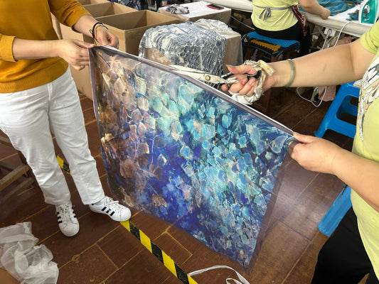 Blue Dream silk being cut at the factory — from tea-printed artwork to textile