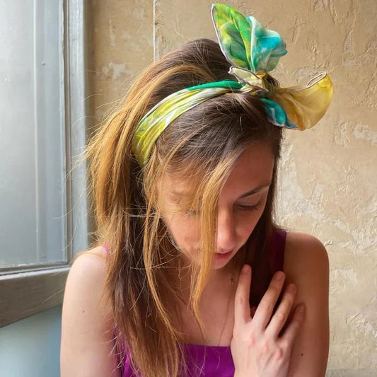 Model wearing Teascarf Brooklyn oversized silk scarf at a restaurant — holiday gift guide for the person who wears art