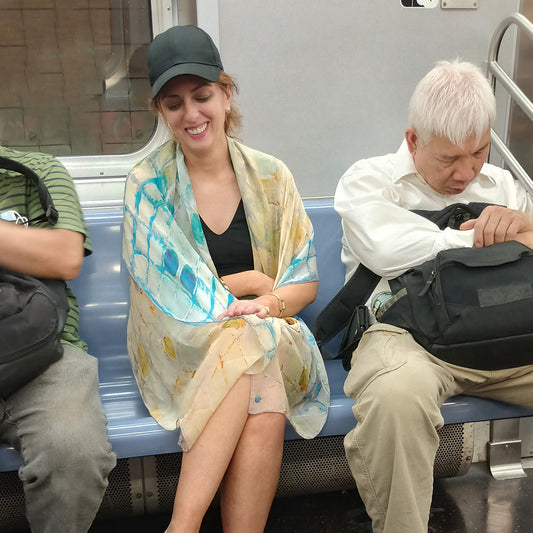 Model wearing Calm Camomile silk scarf on the subway — the person you become when you wear it, Teascarf Brooklyn