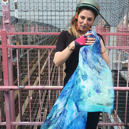 Woman on a Brooklyn bridge wearing Clear Blue oversized silk scarf — Teascarf Brooklyn
