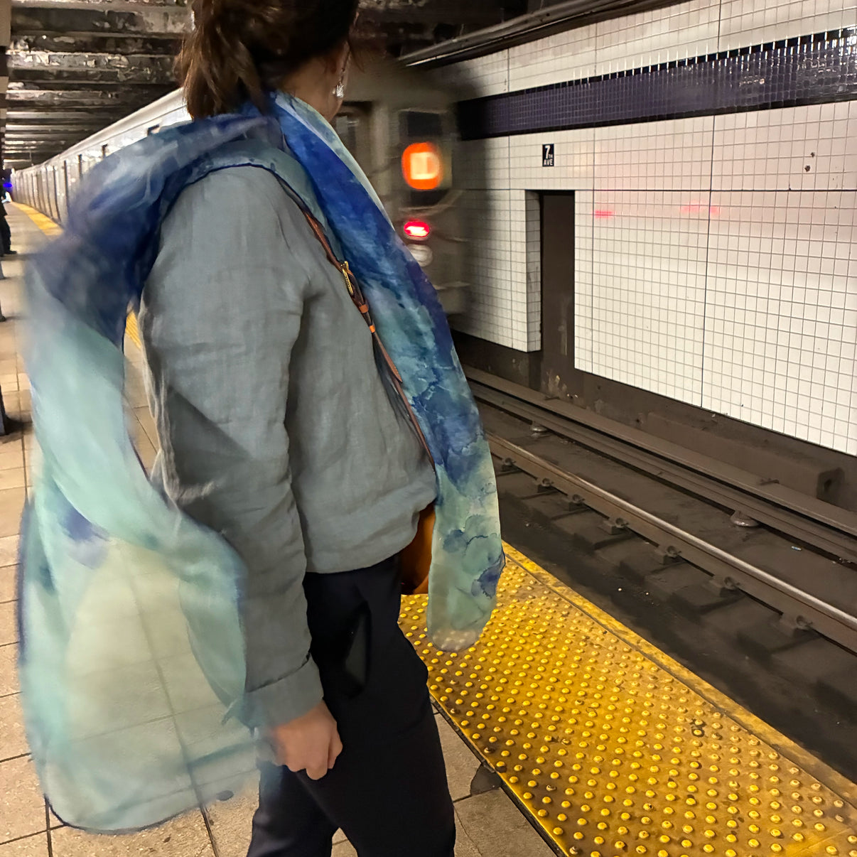 Model wearing Clear Blue oversized silk chiffon art scarf on a New York City subway train — Teascarf Brooklyn