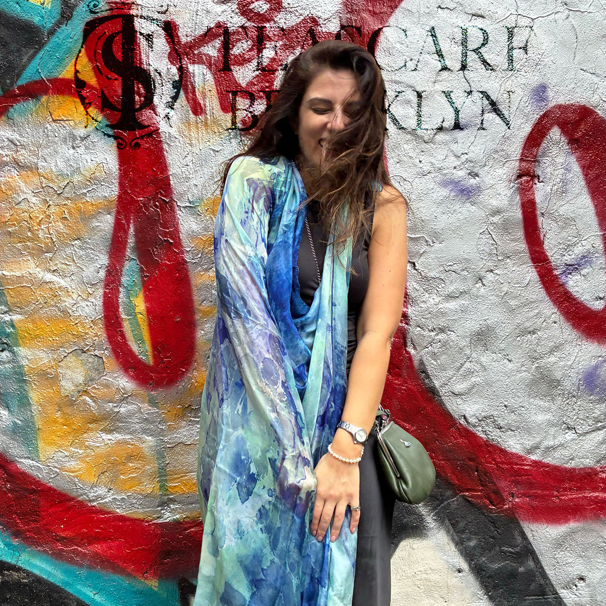 Model wearing Clear Blue Oversized Square Tea-Printed Silk Chiffon Scarf in front of a graffiti wall - 100% Silk, 52x52" - Teascarf Brooklyn