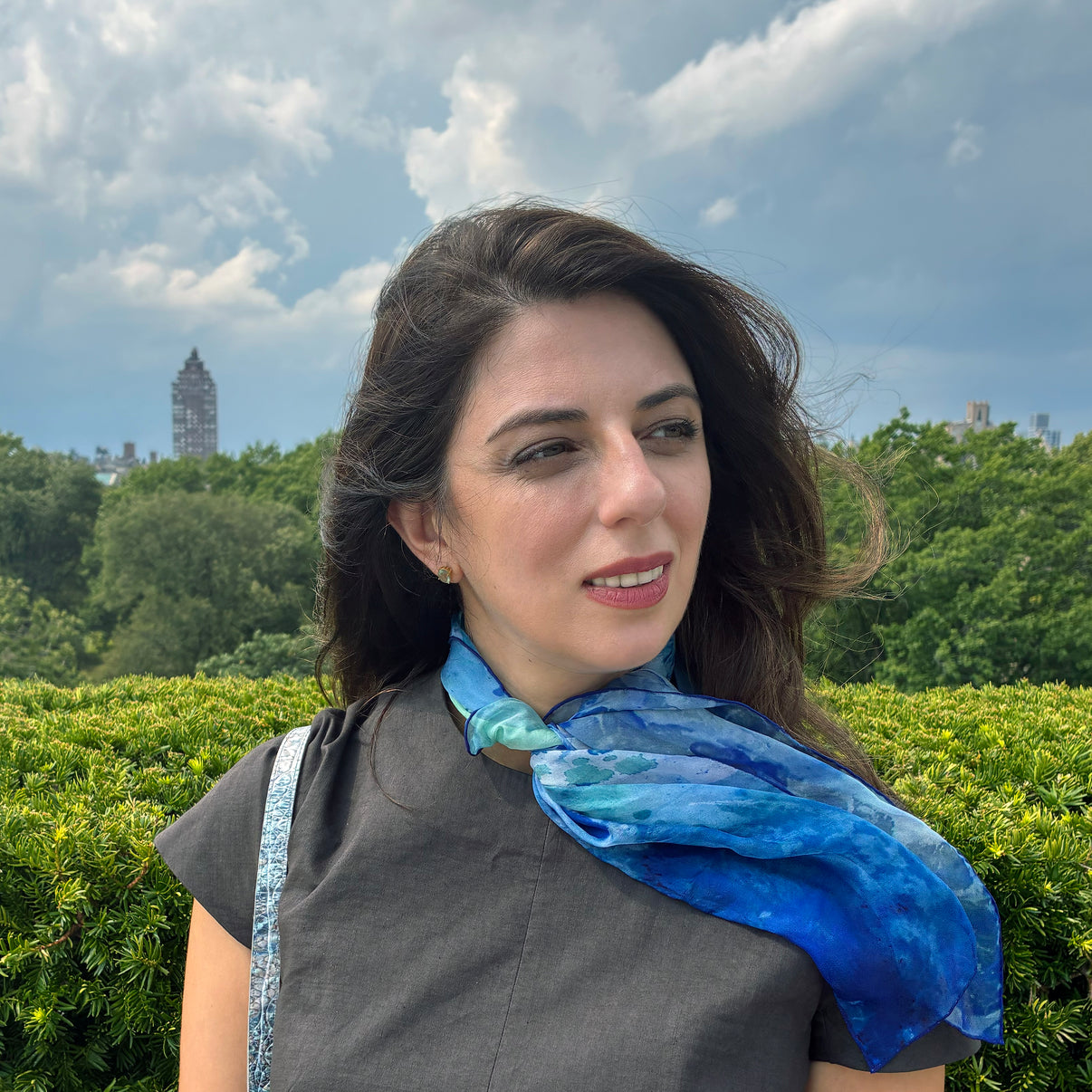 Model wearing Clear Blue tea-printed silk chiffon art scarf, 24x24". Teascarf Brooklyn.