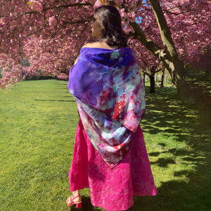 Rear view of model wearing an Oversized Purple Rain Scatp From Teascarf Brooklyn standing on the Cherry Esplanade in the BBG.