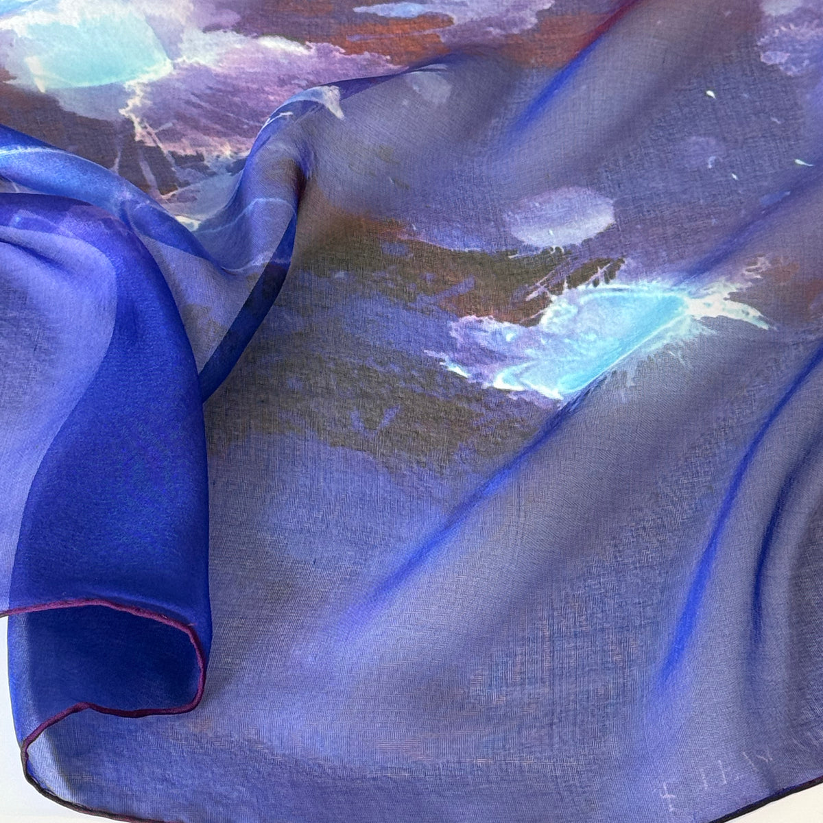 Detail of 100% silk chiffon scarf in vibrant purple and red with hand-rolled and dyed in Love Symbol #2.