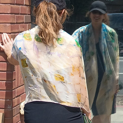 Model sees own reflection in window while wearing Oversized Camomile Scarf from Teascarf Brooklyn