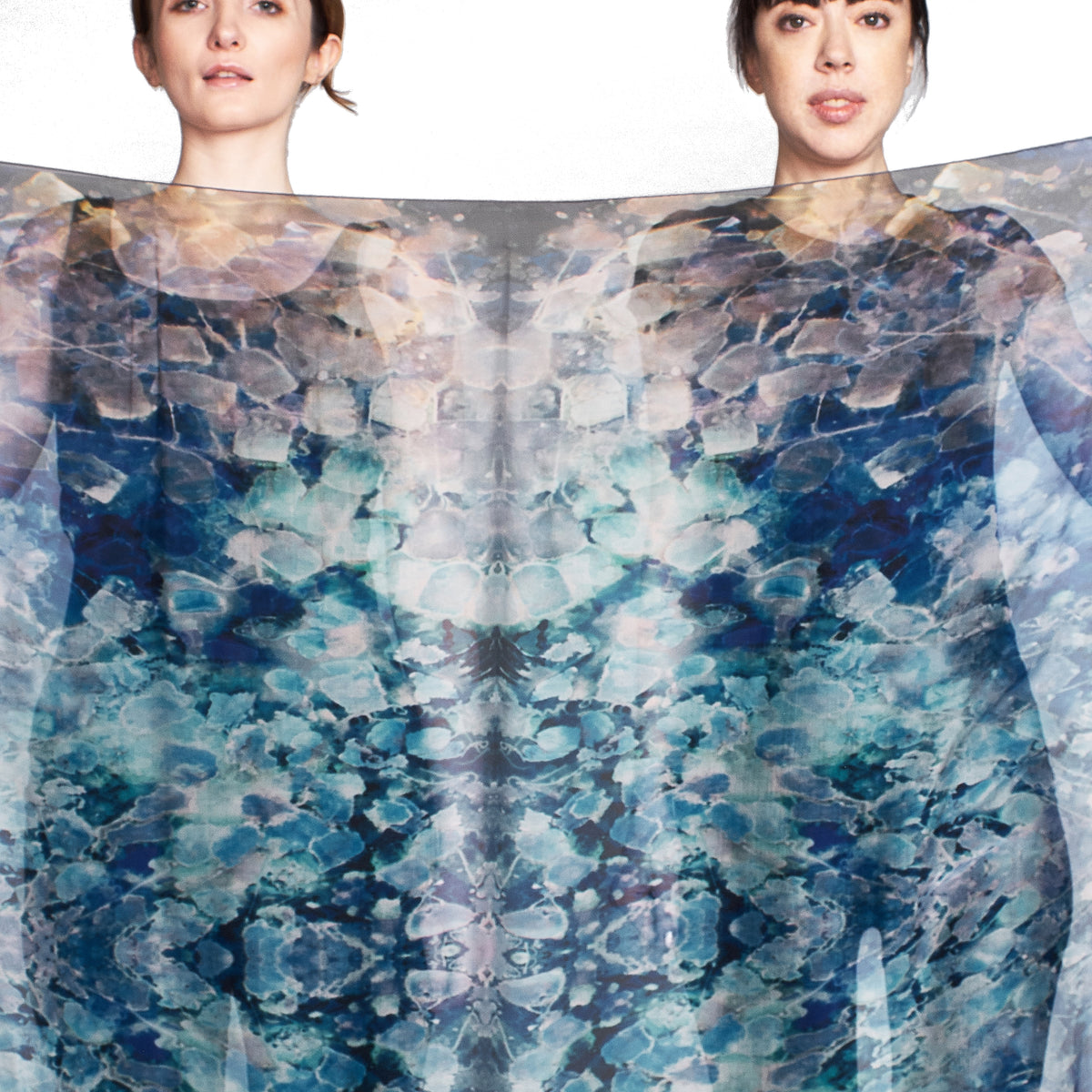 Two models holding the Blue Dream oversized silk chiffon art scarf stretched open to show the full tea-printed pattern, 52x52" wearable art by Teascarf Brooklyn