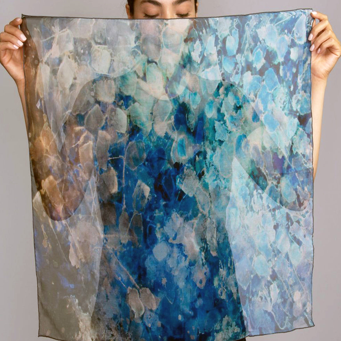 Model holding open Blue Dream Small Square Tea-Printed Silk Chiffon Scarf in front of her face, showing full pattern - 100% Silk, 24x24" - Teascarf Brooklyn